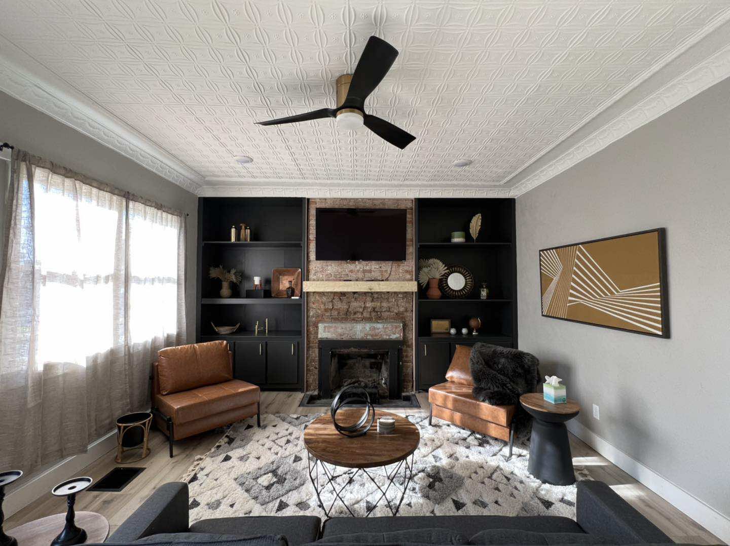 Completed living room interior with fireplace, built-ins, and coffered ceiling